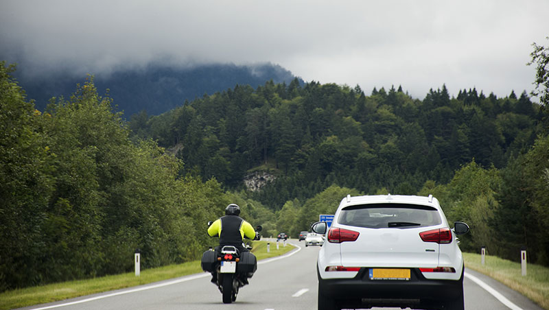 Image of a car and a Motorcycle on a road